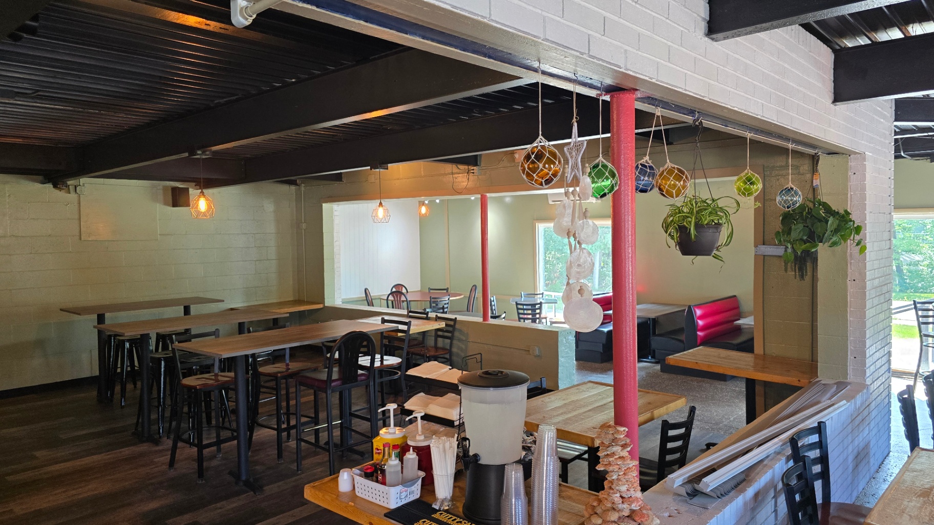 Indoor dining room with booths and high-top tables