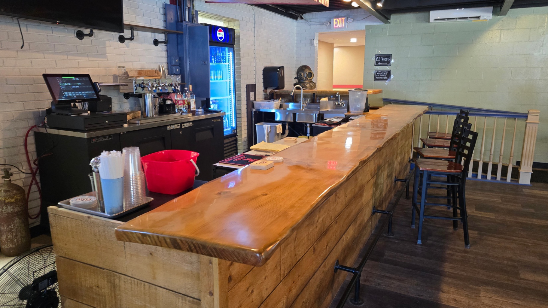 Indoor wooden bar with taps and stools